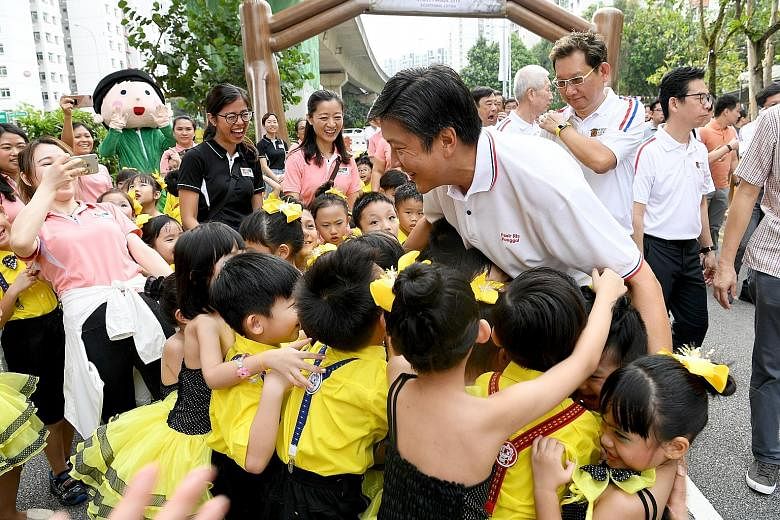 Kindergarten children from the Pasir Ris-Punggol GRC giving a group hug to NTUC secretary-general Ng Chee Meng, who is also Minister in the Prime Minister's Office, at the Pasir Ris-Punggol Inter-Racial and Religious Harmony Street Parade 2019 yester