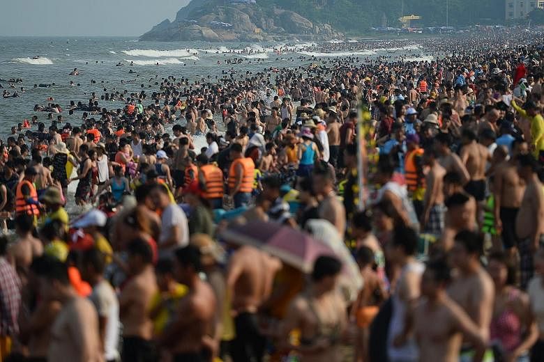 Thousands of day trippers jostling for selfie space and elbowing their way to the sea at north Vietnam's popular Sam Son beach last Saturday, as extra-vigilant lifeguards kept watch over the summer surge. Located in Thanh Hoa province, the beach has 