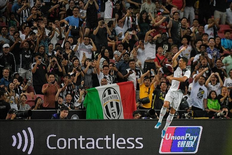 Juventus fans cheer as Portuguese superstar Cristiano Ronaldo does his trademark celebration after scoring against Tottenham during the International Champions Cup match at the National Stadium last night.