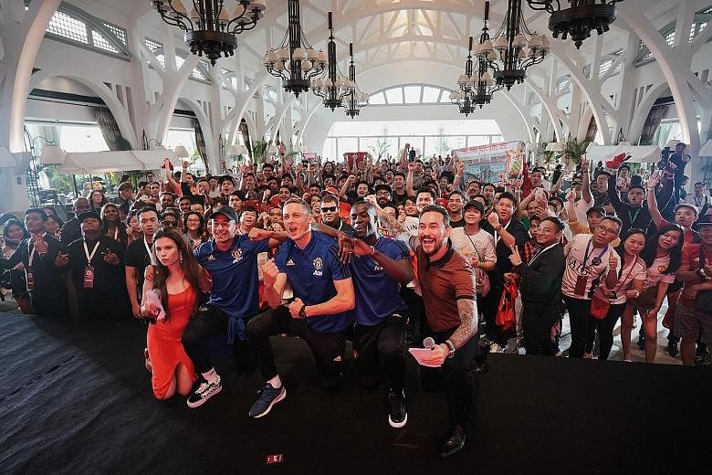 Red Devils (in blue, from left) Jesse Lingard, Nemanja Matic and Eric Bailly cheering with fans at an event organised by Chivas Regal at The Clifford Pier, Fullerton Bay Hotel. 