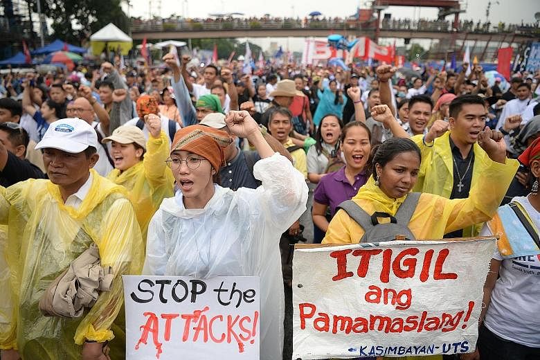 Activists marching towards Congress in a protest to coincide with President Rodrigo Duterte's State of the Nation Address yesterday. PHOTO: AGENCE FRANCE-PRESSE