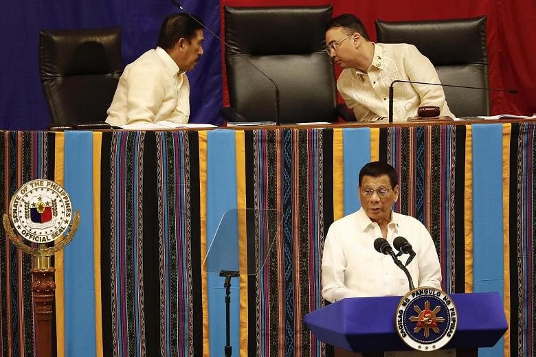 President Rodrigo Duterte making his address as Senate president Vicente Sotto III (left) and House of Representatives Speaker Alan Peter Cayetano confer behind him. Mr Duterte vowed to make the most of the next half of his term.