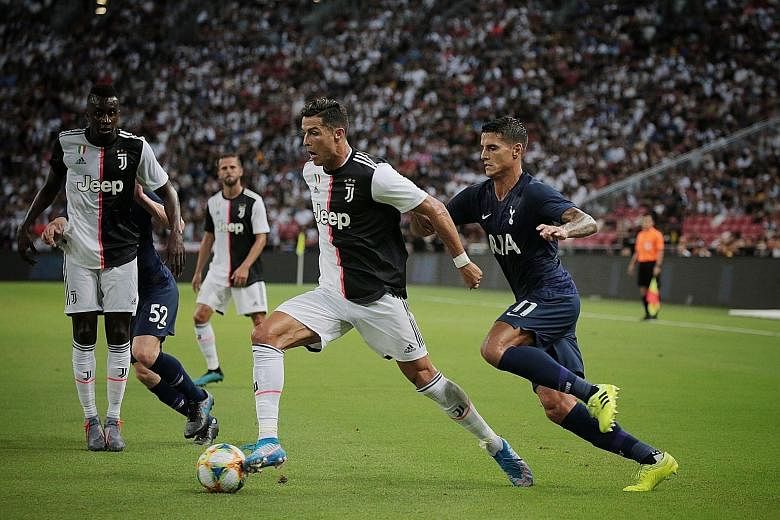 Spurs' Harry Kane left goalkeeper Wojciech Szczesny grasping at thin air for the winner in the English club's 3-2 win over the Serie A champions, and stole the thunder of Cristiano Ronaldo, pursued here by Tottenham's Erik Lamela. 