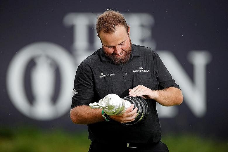 Shane Lowry examines the Claret Jug he won for coming on top at the Royal Portrush Golf Club. The Irishman won the British Open by six strokes for his first Major trophy. PHOTO: REUTERS