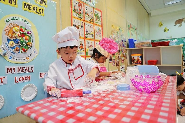 Children role-playing as chefs (above) and having a lesson with Chinese teacher Lu Bin (left) at Zion Kindergarten. The school is holding an open-house carnival to boost enrolment. Pre-schoolers having a gym class (left) at Zion Kindergarten, which i