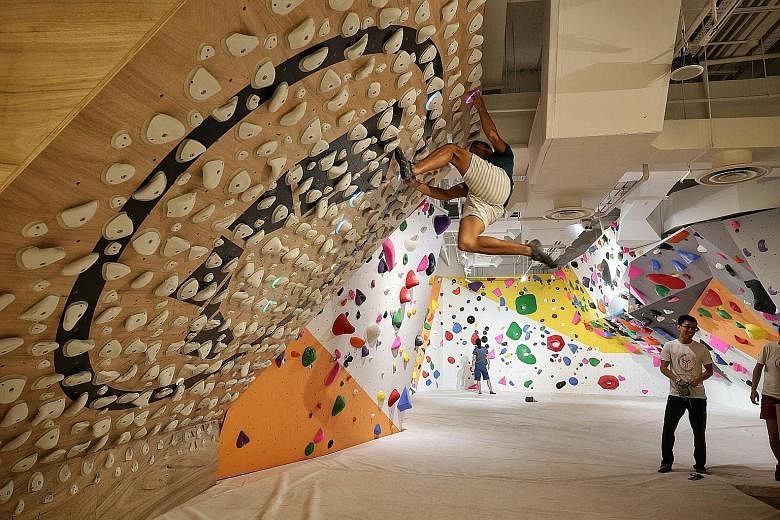 A rock-climbing wall at Funan mall, which reopened this year after a three-year redevelopment. Contributions from Funan and Westgate are expected to "anchor CMT's steady financial performance" as the trust starts revamping Lot One Shoppers' Mall this