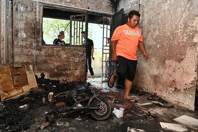 The blackened interior of a flat at Block 224 Ang Mo Kio Avenue 1 after a fire broke out on Monday. The blaze is believed to have been caused by the overcharging of an electric scooter.