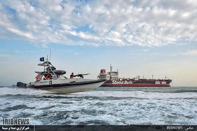 An image grab taken from a broadcast by Islamic Republic of Iran Broadcasting on Sunday showing Iranian speedboats patrolling around the tanker Stena Impero anchored off the port city of Bandar Abbas.
