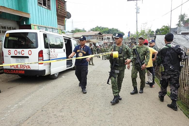 Security officials preparing to cordon off an area in Indanan, Sulu province, for investigation after a blast in June. Foreign extremists were behind the suicide attack, said the head of the military's Western Mindanao Command.