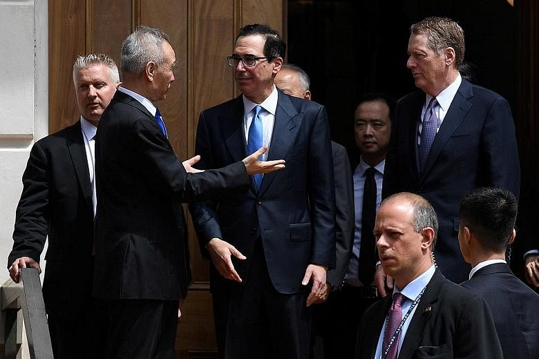 Chinese Vice-Premier Liu He conversing with US Treasury Secretary Steven Mnuchin, with Trade Representative Robert Lighthizer looking on, after trade talks in Washington broke down in May.