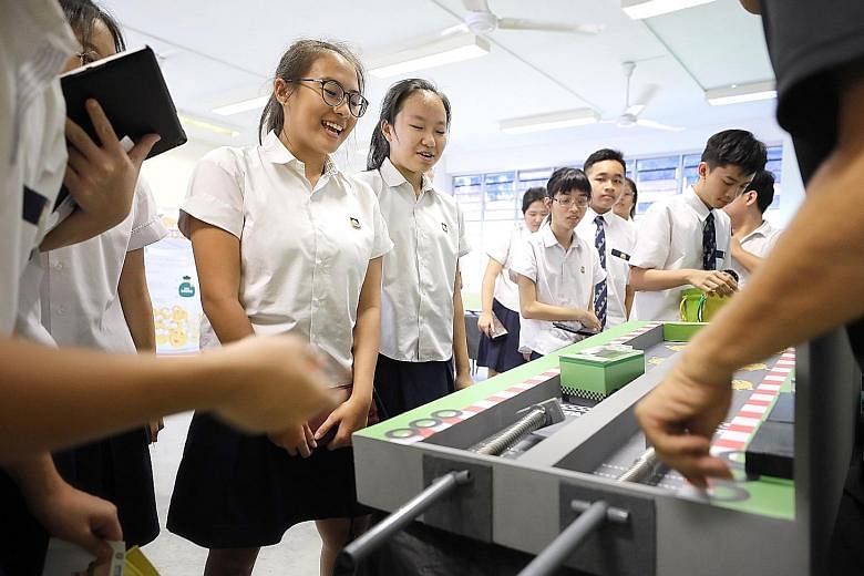 Guangyang Secondary School students playing Race To Save, one of several games organised by the CPF Board at the school yesterday, as part of a programme to motivate secondary and tertiary students to start saving early and learn more about the Centr