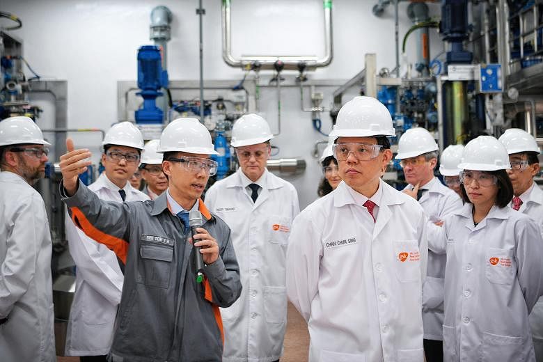 GlaxoSmithKline technical development manager See Toh Yoong Hsiang giving Minister for Trade and Industry Chan Chun Sing a tour of the pharmaceutical company's expanded production building at its Jurong site on July 5. ST FILE PHOTO