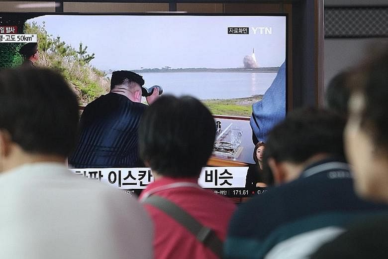 South Koreans watching the news coverage on North Korea's missile launch at Seoul Station yesterday. Seoul said the test posed a military threat. PHOTO: EPA-EFE