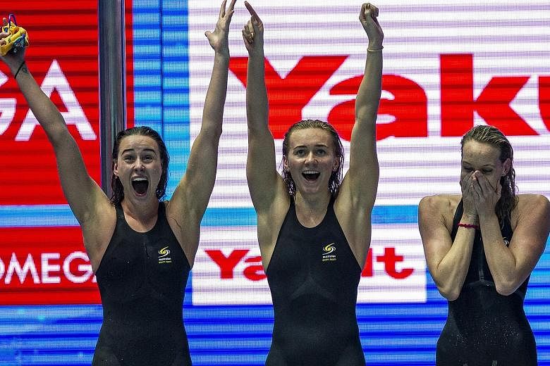 (From left) Ariarne Titmus, Madison Wilson and Brianna Throssell celebrating after Emma McKeon touches home for Australia to win the 4x200m freestyle relay final in a world-record 7min 41.50sec at the Fina World Championships in Gwangju yesterday. Th