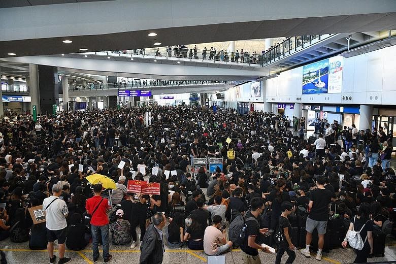 Protesters staging a sit-in yesterday at the Hong Kong airport. In a bid to find new ways to spread their message, the protesters, who included aircrew and workers from the aviation industry, converged on the Terminal 1 arrival hall of one of Asia's 