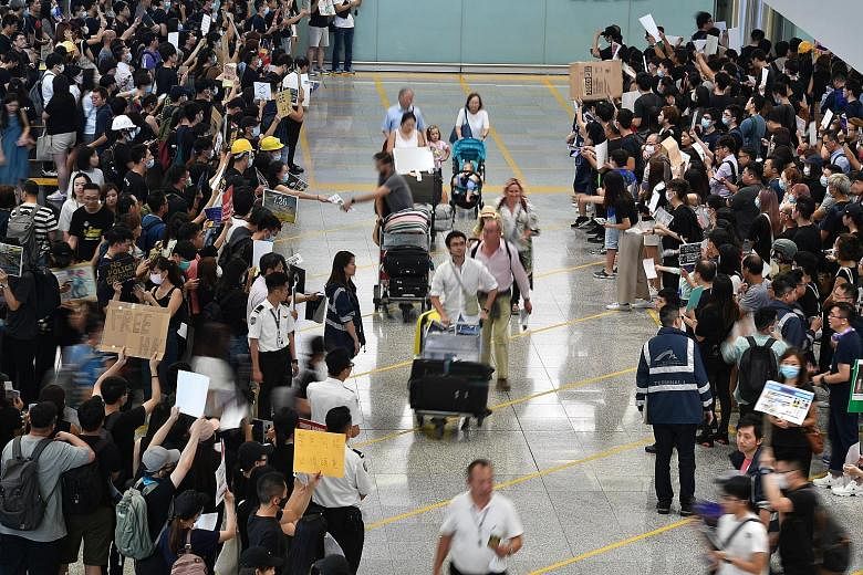 Protesters staging a sit-in yesterday at the Hong Kong airport. In a bid to find new ways to spread their message, the protesters, who included aircrew and workers from the aviation industry, converged on the Terminal 1 arrival hall of one of Asia's 