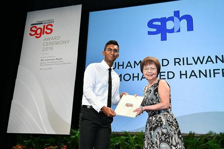 Mr Muhammad Rilwan Mohamed Haniffa receiving his Singapore-Industry Scholarship (SgIS) award from Ms Ingrid Lim, assistant vice-president of human resources at Singapore Press Holdings. The 20-year-old received a full-term SgIS with SPH. 