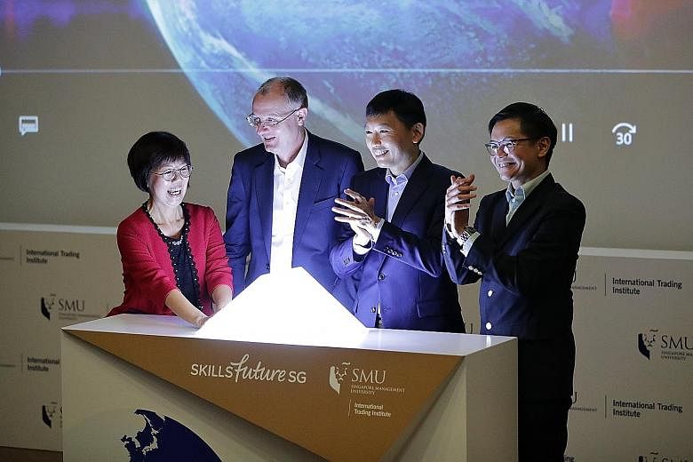 The new iTalent Solutions Map being launched at Singapore Management University yesterday by (from far right) SkillsFuture Singapore chief executive Ng Cher Pong, Senior Minister of State for Trade and Industry and Education Chee Hong Tat, SMU provos