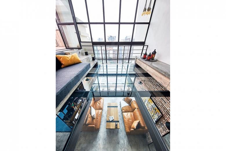 The glass-floor mezzanine creates space, but does not break the visual line of the apartment's double-volume ceiling.