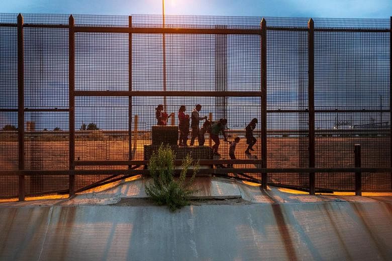A group of migrants from Guatemala walking along the Mexican side of the border wall, near El Paso, Texas, last month looking for an opportunity to seek asylum in the United States. Under the new asylum deal, says the White House, Guatemala would be 