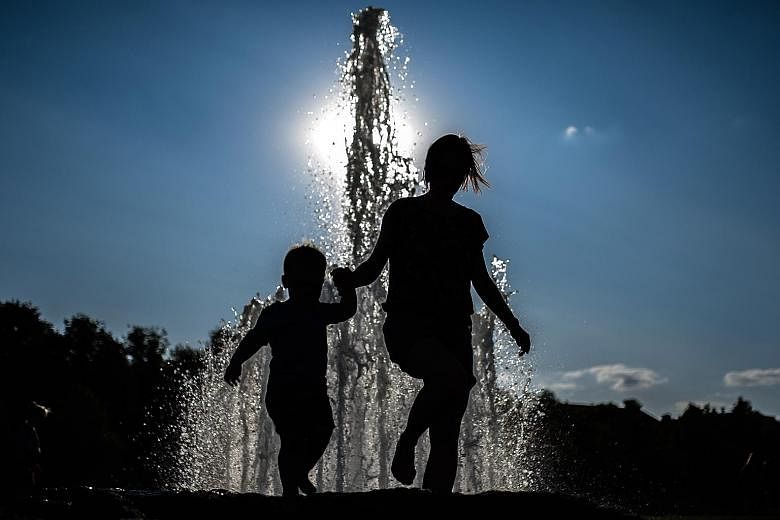 Visitors in front of a fountain at Lustgarten park in Berlin on Friday. Germany saw a national temperature record of 42.6 deg C in the north on Thursday. The heatwave smashed decades-old temperature records across Europe, including in Belgium, the Ne