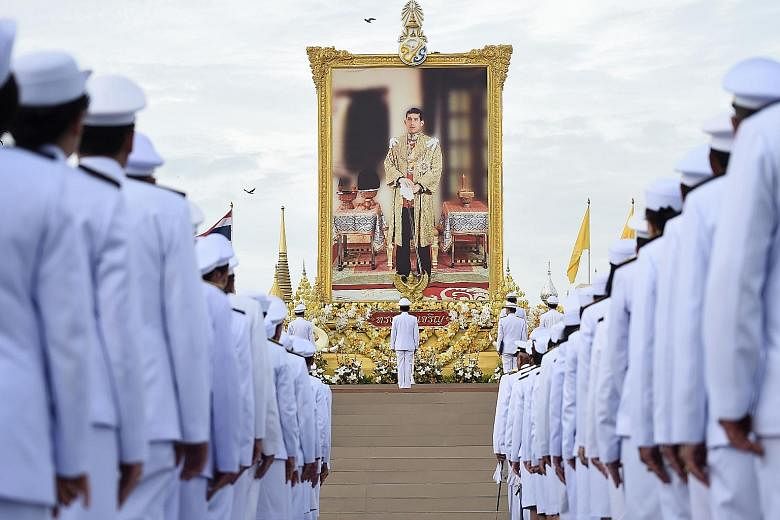Thai Prime Minister Prayut Chan-o-cha (centre) and officials paying their respects before a portrait of King Maha Vajiralongkorn during celebrations for his 67th birthday in Bangkok yesterday. It was the first birthday celebration of the monarch sinc