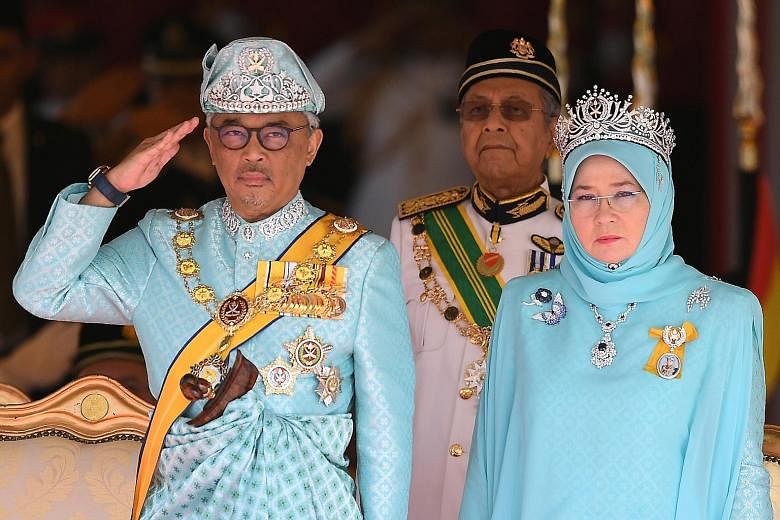 Sultan Abdullah Sultan Ahmad Shah and Tunku Azizah, with Prime Minister Mahathir Mohamad behind. PHOTO: AGENCE FRANCE-PRESSE