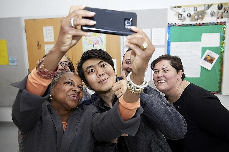 Lang Lang taking a selfie with school administrators at the opening of Lang Lang International Music Foundation's new piano lab at First Avenue Elementary School in Newark in April.