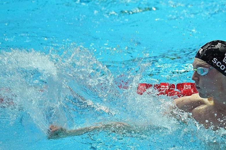 Duncan Scott punching the water to celebrate after anchoring Britain to the gold medal, ahead of the US, in the men's 4x100m medley relay on the final day of the World Championships in Gwangju, South Korea.