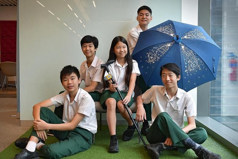 The young entrepreneurs running Qanemate are (clockwise from left) Yuan Jing Shuo, siblings Seng Ian Hao and Seng Ing Le, Brian Tan and Coen Yap. Besides the walking stick holder, the firm is also behind the QaneBrella.