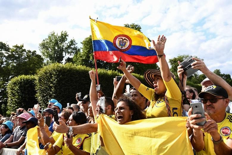 Colombian fans cheering for Tour de France leader Egan Bernal during the final stage from Rambouillet to the Champs-Elysees in Paris yesterday.