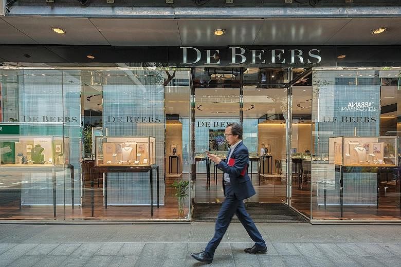 De Beers has loosened rules for gem buyers, known as sightholders, by letting them lower annual quotas and defer purchases. Chief executive Bruce Cleaver says the firm aims to help customers "ride out the storm".