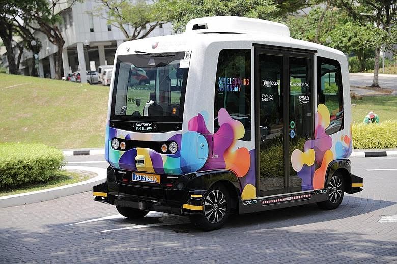Above: The electric shuttle will operate between Heng Mui Keng Terrace and Business Link at 20-minute intervals on weekdays. The service, which is free of charge, will not operate when it rains. Below: At the launch of the shuttle trial at NUS yester
