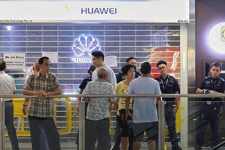 Some members of the public seen outside the Huawei store at Nex shopping mall in Serangoon on Friday. Many consumers who queued up for the Huawei Y6 Pro were disappointed and angry. Huawei has apologised for the insufficient supply, saying it had rec