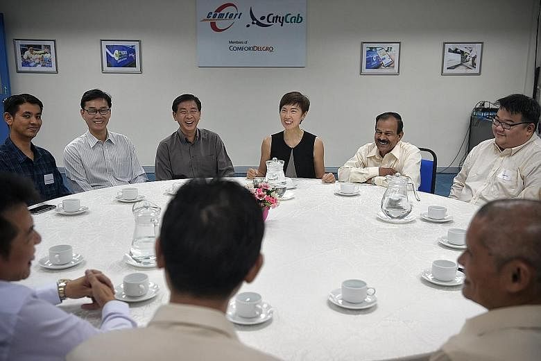 Cabbies attending a SkillsFuture for Digital Workplace class yesterday. The one-day programme is aimed at training 10,000 workers on how to better use technology in their jobs. Manpower Minister Josephine Teo, ComfortDelGro Taxi CEO Ang Wei Neng (thi