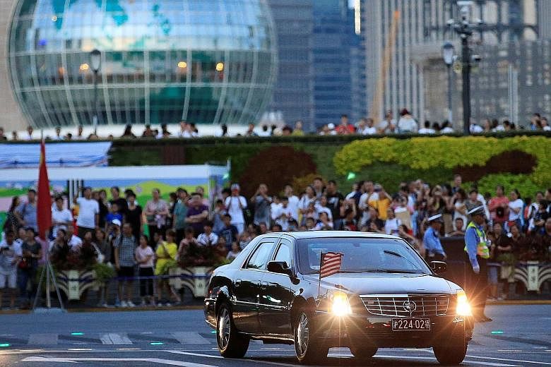 Above: The police moving the crowd ahead of the arrival of the US delegation, which includes Treasury Secretary Steven Mnuchin and Trade Representative Robert Lighthizer, in Shanghai yesterday. Below: A car with a US flag arriving at the Fairmont Pea