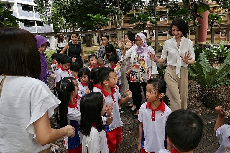 Senior Parliamentary Secretary Sun Xueling (far right) greeting PCF Sparkletots pre-schoolers in Fengshan yesterday with fellow PAP Women's Wing members (beside her, from right) Rahayu Mahzam, Cheryl Chan, Cheng Li Hui (in black dress) and Intan Azur
