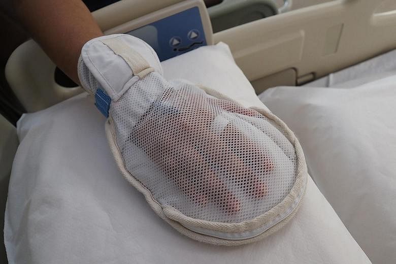 The new mitten has a zip to allow nurses to access a patient's fingers to take blood tests or check his vital signs.