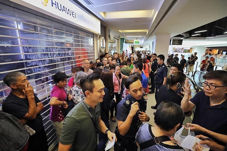 A crowd (left) outside the Huawei store at Nex mall last Friday. Police had to be called in at many outlets to manage the angry crowds. The promotion was cut short when the 27 stores selling the Y6 Pro sold out almost immediately (above), in some cas