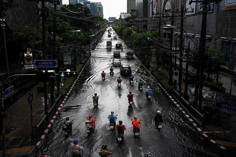 A flooded Bangkok street after heavy rain last month. Other parts of the country experienced the worst drought in years and led the authorities to cut estimates for crop production. Cloud-seeding planes have been deployed, and pumps and trucks have b
