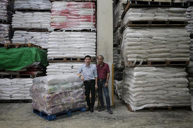 See Hoy Chan operations manager Lim Ek Kwong and Singapore General Rice Importers Association chairman Michael Hiu (far right) say firms that import Thai rice are feeling the pinch from the rising baht. Mr Lim expects to pay US$1,300 (S$1,779) for a 