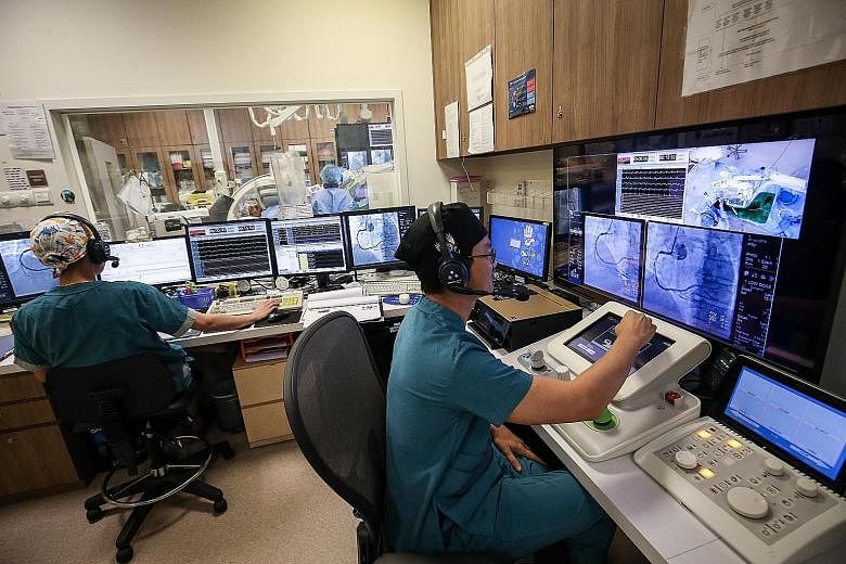 Tan Tock Seng Hospital's team is the first in South-east Asia to use this new technology to perform robotic-assisted angioplasty. The surgeon controls the robotic arm from a workstation outside the operating theatre.
