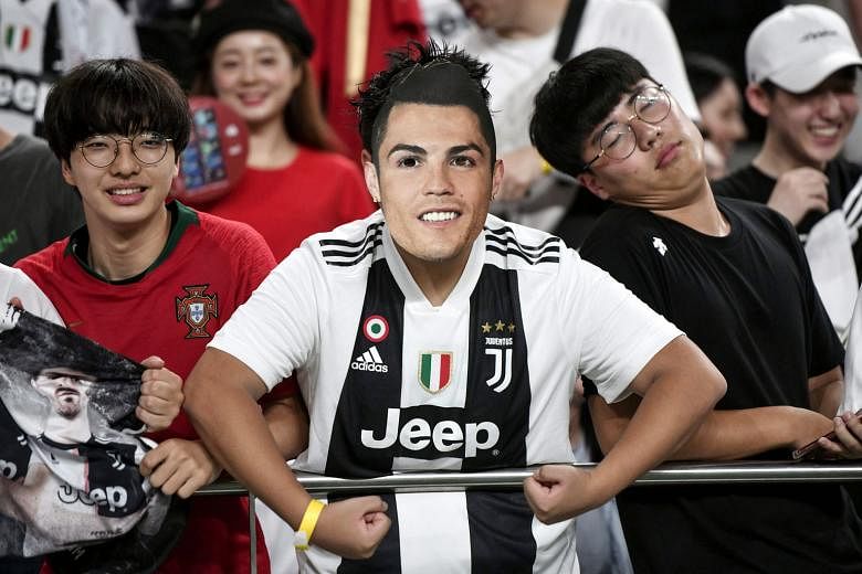 Fans at Juventus' friendly match against a K-League all-star team in Seoul on Friday. Many in the 60,000 crowd left before the final whistle when it became clear Cristiano Ronaldo would not play. PHOTO: AGENCE FRANCE-PRESSE