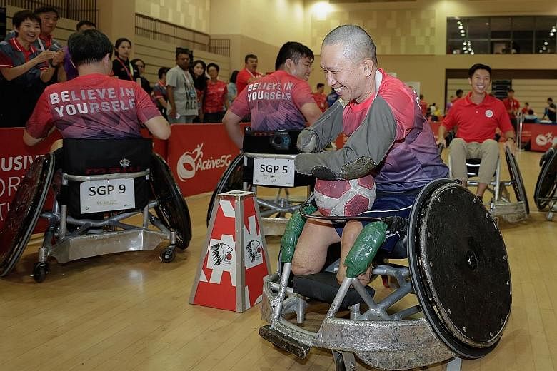 Tan Whee Boon, 54, trying out different sports at the Inclusive Sports Festival at Our Tampines Hub yesterday. Minister for Culture, Community and Youth Grace Fu believes that everyone should have access to sport, regardless of whether one has specia