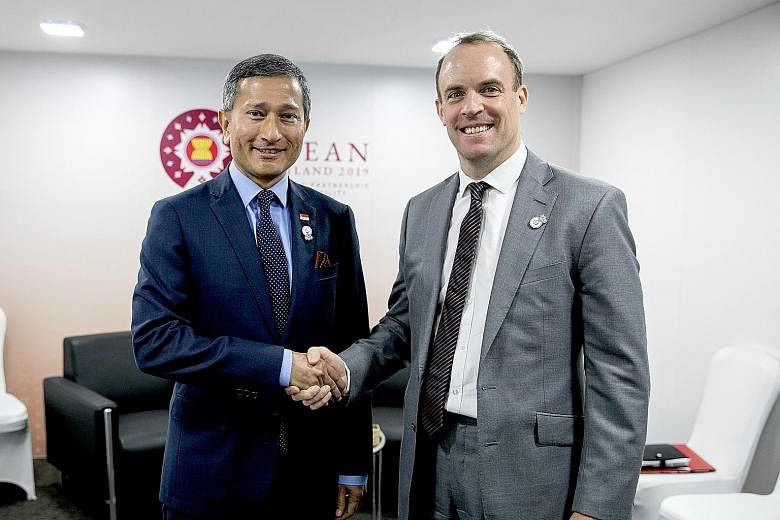 Singapore Foreign Minister Vivian Balakrishnan meeting British Foreign Secretary Dominic Raab on the sidelines of the Asean Foreign Ministers' Meeting in Bangkok yesterday. Dr Balakrishnan congratulated Mr Raab on his appointment to the post last wee