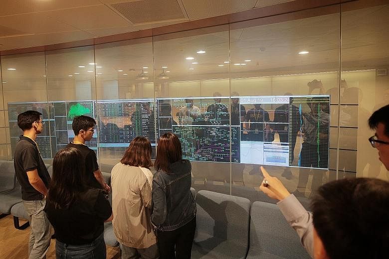 Polytechnic students in the viewing gallery of the Energy Market Authority's Power System Control Centre yesterday.