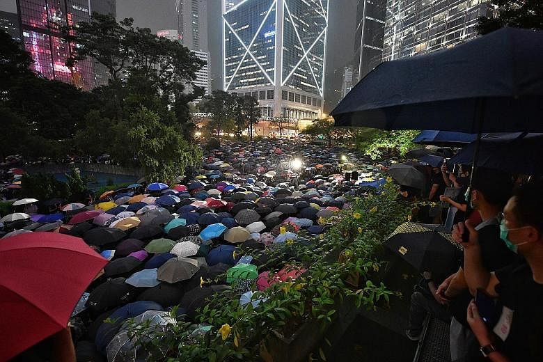 Chater Garden, in the heart of Hong Kong's business district, and its surrounding areas were turned into a sea of umbrellas last night as 13,000 civil servants gathered despite an evening shower to show their support for the anti-extradition movement