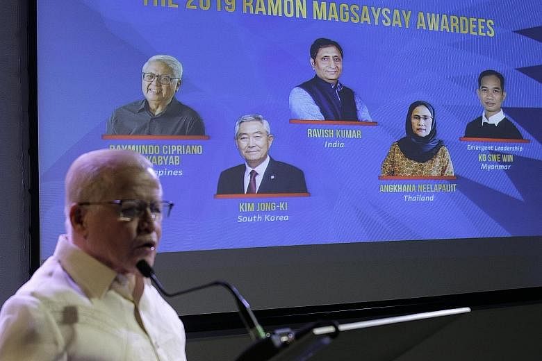 Mr Jose Cuisia Jr, chairman of the award foundation, unveiling the five winners of the Ramon Magsaysay Award during an event in Manila yesterday. PHOTO: ASSOCIATED PRESS