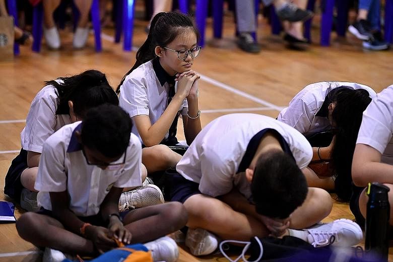 Pupils waiting for the release of their PSLE results last year. Parents have expressed concern over Foundation-level subjects under the new PSLE scoring system, but MOE has made it clear that while the 2021 scoring system is doing away with pinpoint 