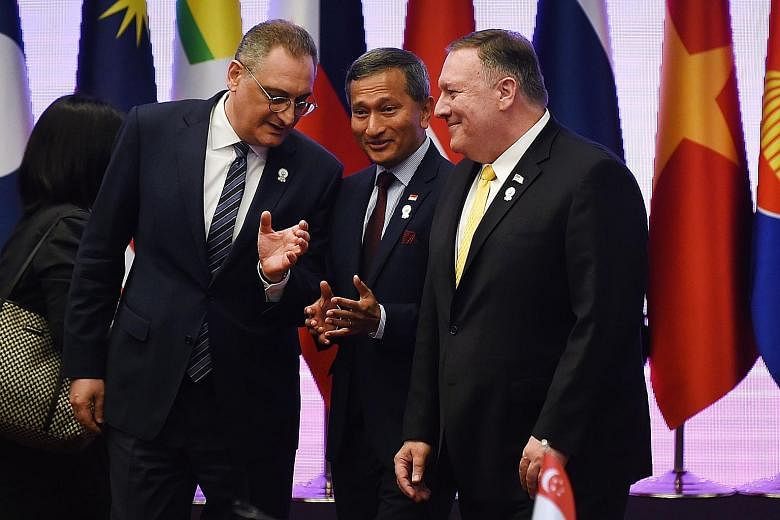 Above: Foreign Minister Vivian Balakrishnan and his Chinese counterpart Wang Yi in Bangkok yesterday. Left: Dr Balakrishnan flanked by Russia's Deputy Foreign Minister Igor Morgulov (far left) and US Secretary of State Mike Pompeo at a meeting in Ban